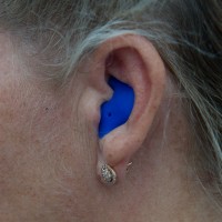 Blue Slimline NoiseBreakers in the ear